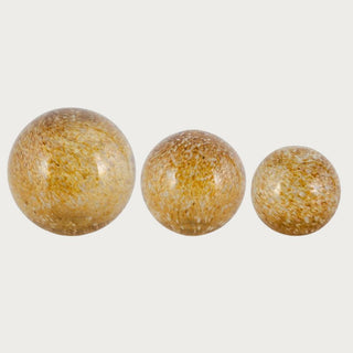 Set of three brown and gold speckled glass globes in graduated sizes on neutral background – handcrafted decorative spheres with warm reflective finish for tabletop or console display.