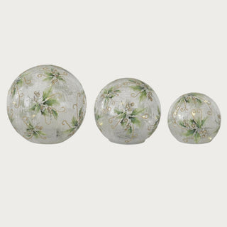 Set of three holly and faux snow crackled glass LED globes with gold glitter accents – elegant handcrafted holiday décor with built-in 6-hour timer for mantel or tabletop styling.