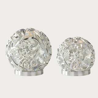 Set of two silver scrolled snowflake LED water spinning globes with swirling glitter and warm light – elegant handcrafted holiday décor with 5-hour timer for tabletop or mantel styling.