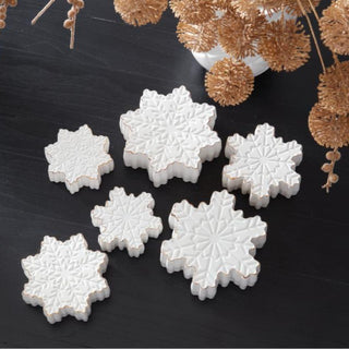 Set of 3 white dolomite tabletop snowflakes with embossed detailing and gold edges styled on black table — elegant winter and holiday home décor by Third & Main.”