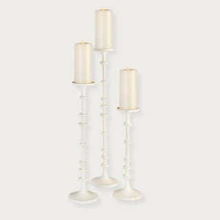 Set of three tall white aluminum pillar candle holders with a sculptural design, displayed with pillar candles (not included); ideal for modern or transitional or modern farmhouse home décor. Fall decor, Winter Decor, Holiday decor