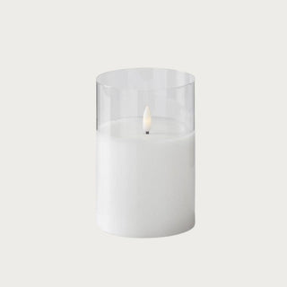 Short white LED flickering flameless candle in clear glass cylinder, 5 inches high by 3 inches wide, battery-powered with 5-hour on/19-hour off timer — compact cozy glow for trays, nightstands, and layered holiday vignettes.