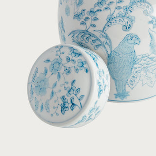 Small blue and white ceramic ginger jar with parrot and botanical pattern and classic lidded silhouette