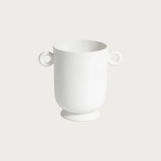 Small white ceramic planter with loop handles and rounded sculptural shape, styled as a minimalist decorative vessel