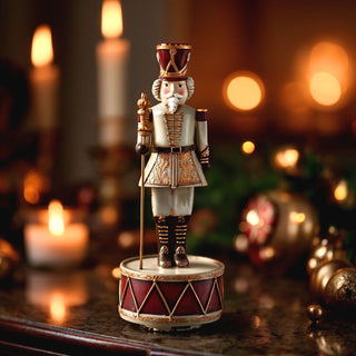 10.75-inch spinning nutcracker music box with burgundy and gold detailing — elegant holiday décor by Third & Main.