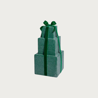 Stack of green gift boxes tied with a green ribbon on a light gray background.