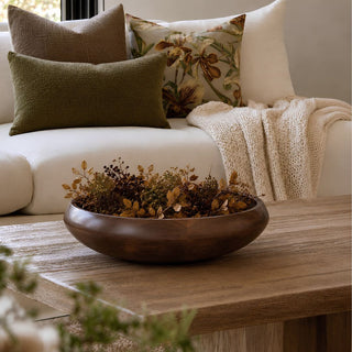 15.5-inch hand-carved mango wood decorative bowl filled with dried fall botanicals, styled on a wood coffee table in a warm neutral living room.
