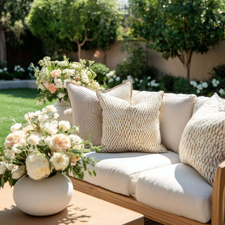 Styled on a contemporary decors style outdoor sofa with beautiful landscaping in the backyard, 22" Luxe Geo Indoor/Outdoor  Lumbar Pillow in Cream and beige