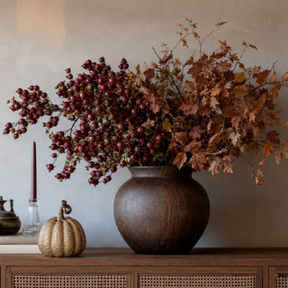 5.25 inch gold embossed resin pumpkin styled on a wood console beside burgundy berries, autumn branches and a dark decorative vase for refined fall home decor.