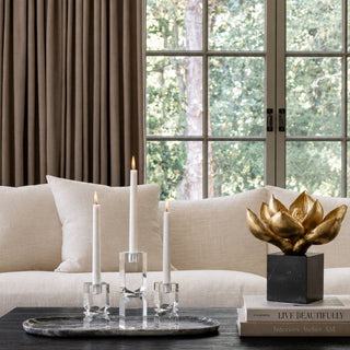 Black, gray and white marble decorative tray styled on a coffee table with clear crystal taper candle holders in a modern transitional living room.