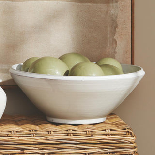 This hand-thrown terracotta bowl is finished with a warm white glaze and has soft visible throw lines which only add to its character. Well-scaled for a stunning tabletop moment, add some colorful orbs or simply beautiful displayed as is.
Details: Dimensions: 18.75 x 18.75 x 7.25 Material: Terracotta, Care & Use: Handcrafted by skilled artisans, each piece is an original and varies in size and color. Dust with dry cloth. Protect fine furniture by lining the interior of the pottery when necessary. Third&Main