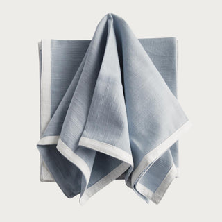 Bring a touch of softness to the table with this set of four 100% woven cotton napkins. Beautiful in tone and texture, the white &amp; blue combination is made to add a pop of color to any tablescape.
Details:
Dimensions: 18"x18", Color: Blue/White, Material: Cotton, Set of Four Napkins, Care & Use: Machine wash cold with like colors, gentle cycle. Do not bleach. Line dry. Warm iron. Do not dry clean.
Third & Main, Home Decor, Textiles, Kitchen, Hostess, Modern Farmhouse, Modern Traditional, White trim