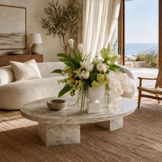 The Garden Room Floral Bundle styled in a white vase with white orchids, green snowballs, white protea, creamy ginger stems, anthurium, calla leaf, white lily of the valley, and lush greenery for elevated coastal and garden-inspired home decor.
