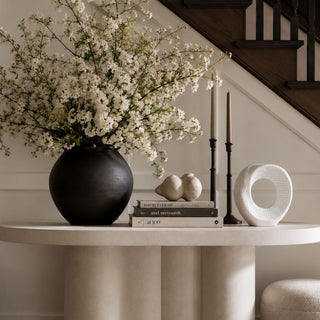 White Woven Texture Ceramic Sculpture styled on a wood console with a round mirror, neutral lamp, candle, books, and greenery for a layered tabletop look.