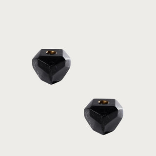 Pair of 4 inch Trinity Black Marble Taper Candle Holders with faceted black marble bases, brass-tone taper openings, and natural stone veining for contemporary tabletop styling.