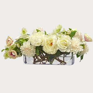 True Bloom 25 Inch Cafe Au Lait Real Touch premade floral arrangement with ivory peonies, roses, hellebores, and soft blush florals arranged in a thick-cut rectangular glass vase with permanent botanical resin, luxury faux floral centerpiece for dining tables, consoles, and modern coastal interiors.