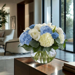 True Bloom Blue Hydrangea Garden Arrangement with blue real touch hydrangea and white roses styled in modern transitional interior with sculpted glass vessel