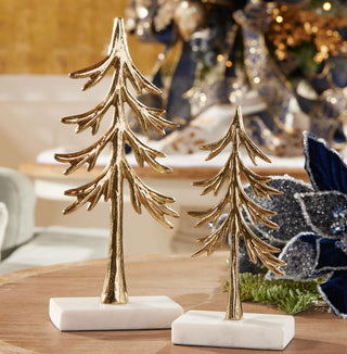 Two gold decorative trees on marble bases with a festive background.
