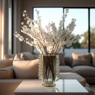 Green braided glass vase with sculptural twisted detailing and soft translucent finish, styled as an elegant decorative accent styled beautifully with cherry blossom stems and resting on a side table