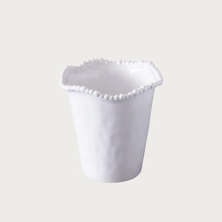 white beaded utensil holder made of melamine styled on kitchen counter holding wooden cooking utensils