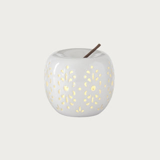 White ceramic cutout LED apple with warm internal glow, styled as an understated decorative accent for home décor