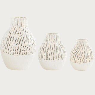 Set of three white semi-gloss ceramic latticework vases in graduated sizes, featuring sculptural pierced detailing and solid ceramic bases on a clean background.