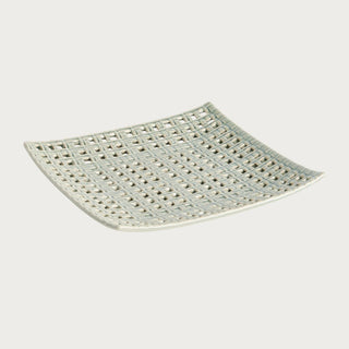 Woven square clay tray with open lattice design and soft neutral glaze, styled as a sculptural decorative accent