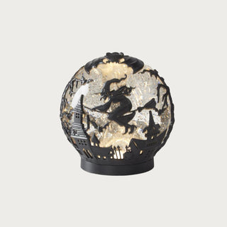 6.5-inch black witch water-spinning LED globe with illuminated silver sparkle interior and witch-on-broom Halloween design.