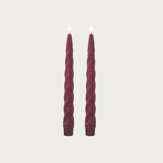 Set of two burgundy spiral flameless LED taper candles with warm white light, 9.75 inches tall.