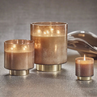 Cortina Small Candle, Tobacco Flower, shown at an angle highlighting the gold jar detailing