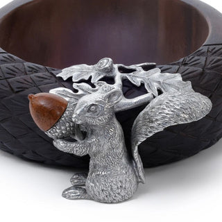 Close-up of the Hartwell wood nut bowl showing the detailed pewter squirrel holding an acorn with sculpted oak leaves and textured dark wood trim.