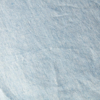 Light blue European linen throw blanket, draped over furniture