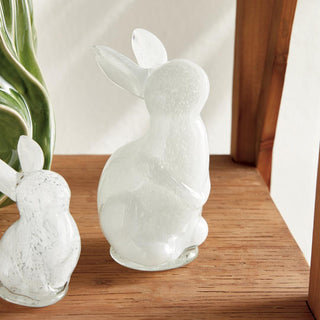 The Lilly Belle white glass bunny sculpture, large size, styled on coffee table
