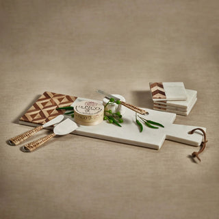 Marble and wood cheese board shown at an angle highlighting the chevron wood grain pattern