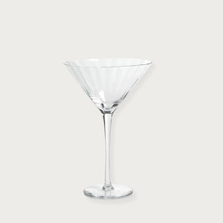 Single optic-cut clear martini glass shown in detail highlighting the coupe shape and glass texture