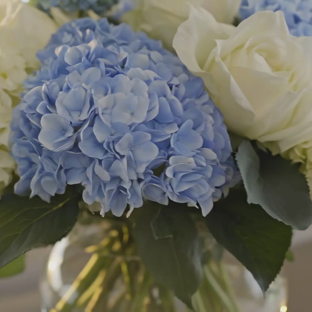 Thea true bloom real touch blue and white hydrangea stems with roses and austen roses premade artificial floral arrangement styled on a luxury console table in a modern contemporary decor style home