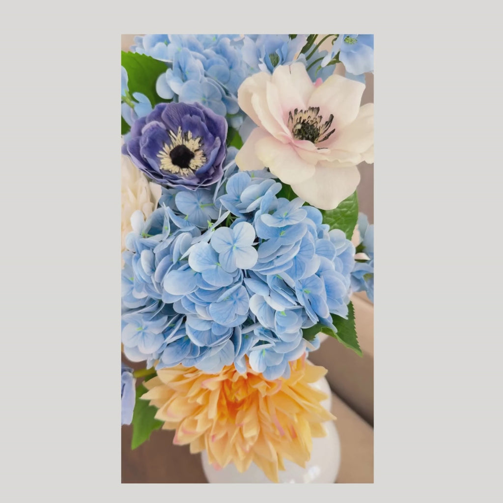 A video of the Azure Garden Summer Premade Floral arrangement- vase not included. A summer modern farmhouse appropriate mix of blue, yellow, white and light pink blooms