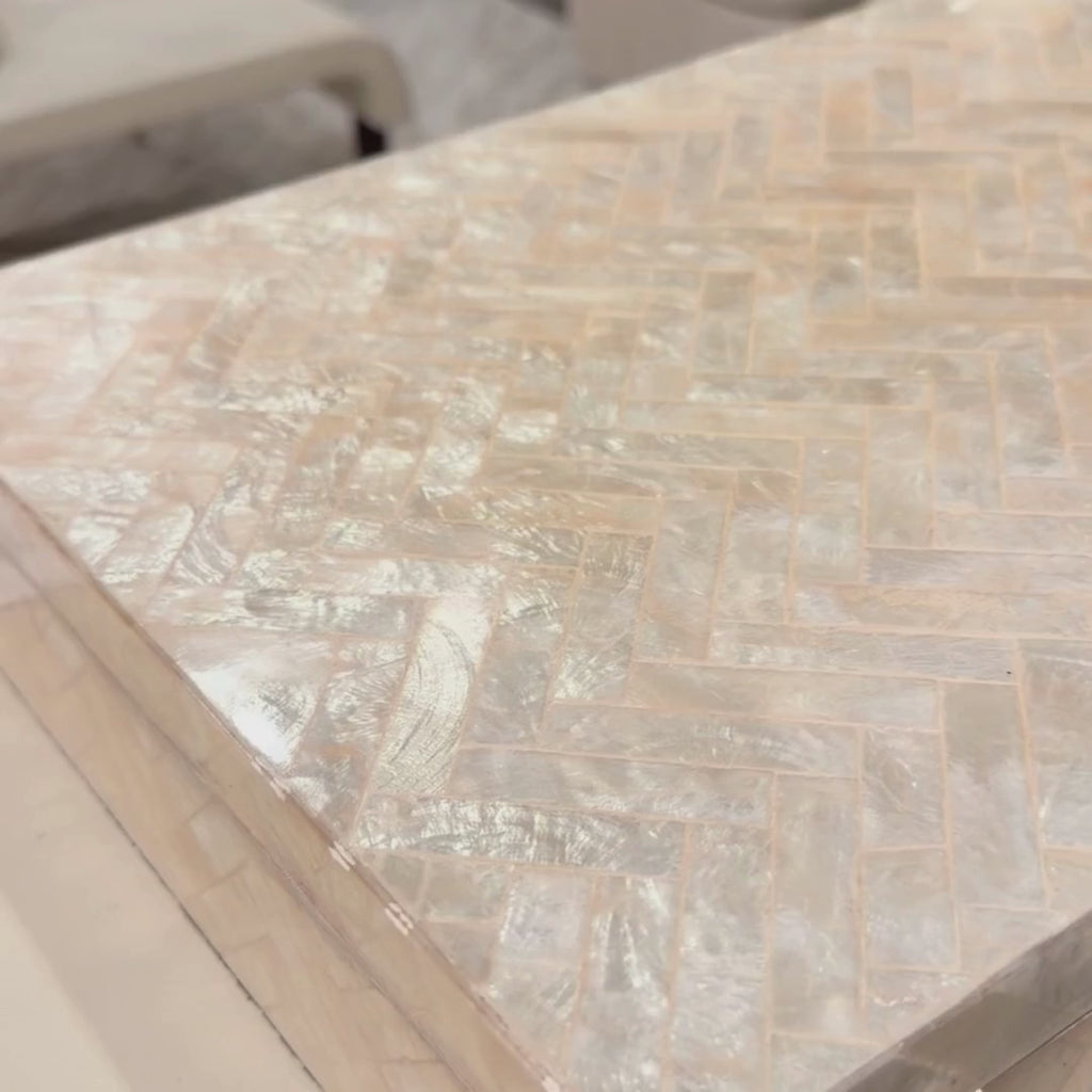 Close-up video of the 16.25 Inch Pearl Capiz Shell Decorative Box showing the natural iridescence, tonal variation, and herringbone-style shell pattern as it catches the light.