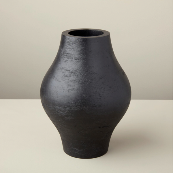 Hand carved mango wood vase with a black food safe coating and not intended for live floral arrangements