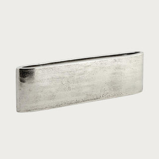 Silver aluminum Joss Vase, low horizontal vase shown empty against a neutral studio background