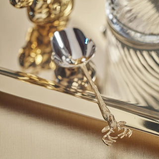 Stag head ice scoop with gold handle and polished steel scoop styled on a bar cart