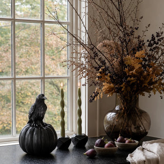 8.25 Inch Black Resin Evermore Crow and Pumpkin styled as a Halloween accent, with a sculpted crow perched on a ribbed black pumpkin and silver-highlighted feather detail.