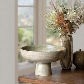 Decorative Playa pedestal ceramic bowl and vase on a wooden surface with a blurred window background