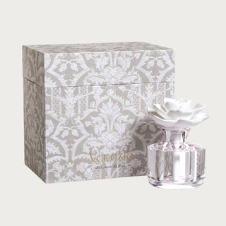 The Gabriella Porcelain Diffuser with crystal-shaped glass body and white porcelain flower topper, front studio view