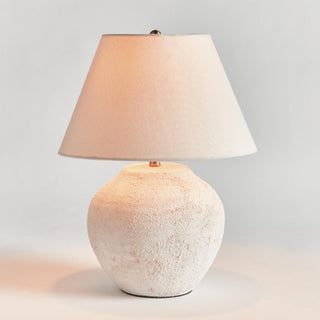 The Theo Table Lamp shown from a second angle, textured ceramic body with linen shade styled on a console table