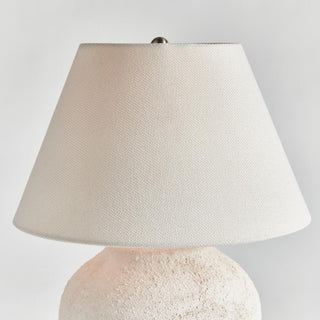 The Theo Table Lamp shown from a third angle, textured ceramic body with linen shade styled on a console table