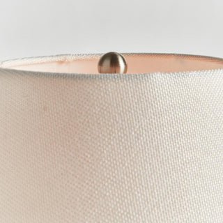 The Theo Table Lamp, cold-paint textured ceramic body with light linen shade, just under 15 inches tall, Third & Main