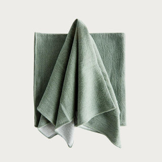 Vanna green cotton dinner napkin set of 4, folded and tied with ribbon